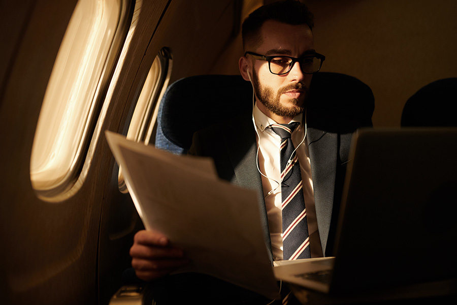 man reviewing his paperworks in a private jet plane